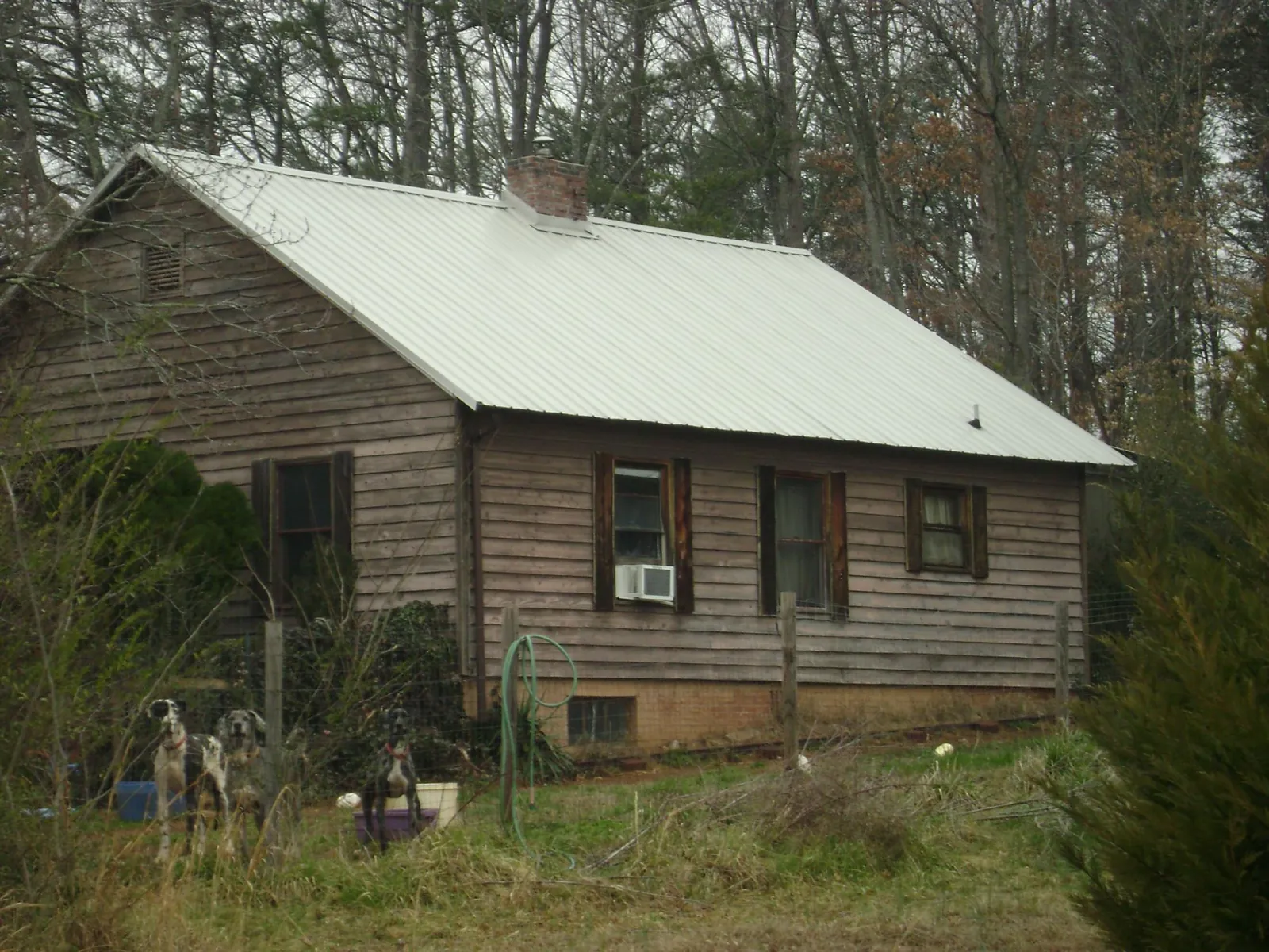 White metal roof on an old wood sided farmhouse, from a Metal Roof Installation job in Clarksville
